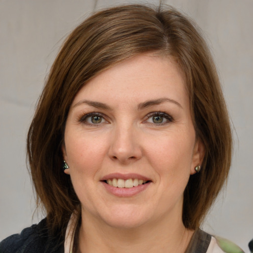 Joyful white young-adult female with medium  brown hair and green eyes