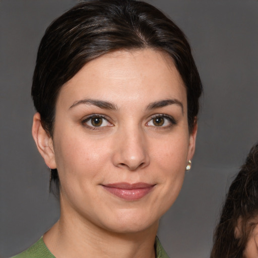 Joyful white young-adult female with medium  brown hair and brown eyes