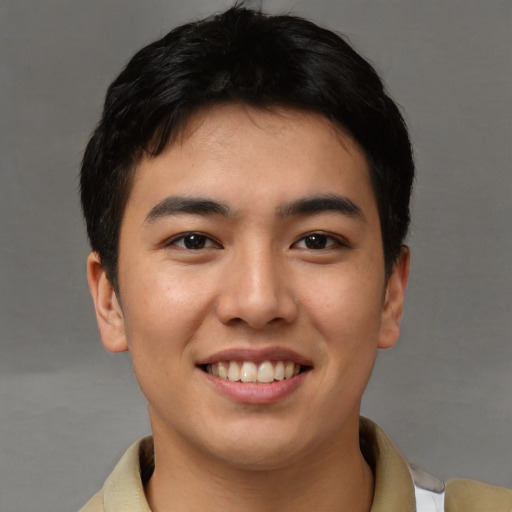 Joyful asian young-adult male with short  brown hair and brown eyes