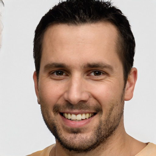 Joyful white young-adult male with short  brown hair and brown eyes