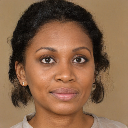 Joyful black young-adult female with medium  brown hair and brown eyes