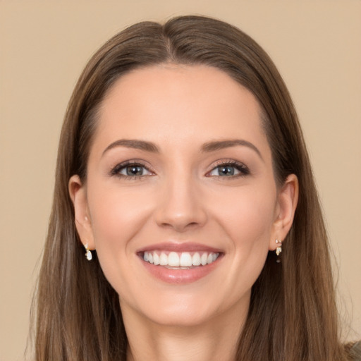 Joyful white young-adult female with long  brown hair and brown eyes