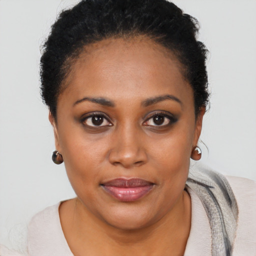 Joyful black young-adult female with short  black hair and brown eyes