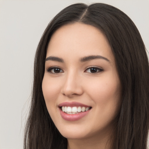 Joyful white young-adult female with long  black hair and brown eyes