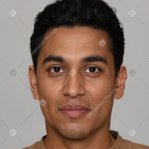 Joyful latino young-adult male with short  black hair and brown eyes