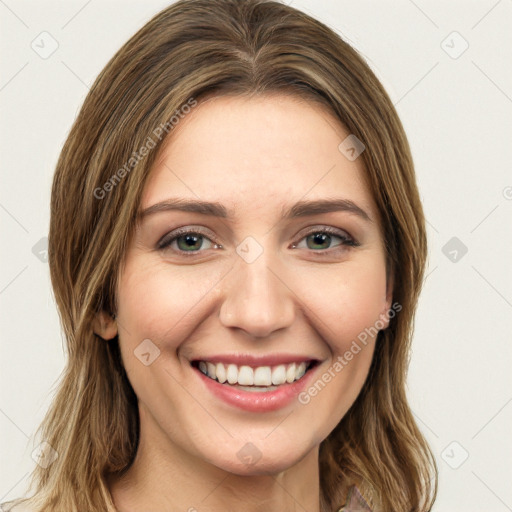 Joyful white young-adult female with long  brown hair and green eyes