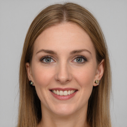 Joyful white young-adult female with long  brown hair and green eyes