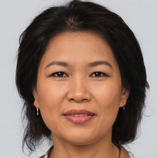 Joyful asian adult female with medium  brown hair and brown eyes