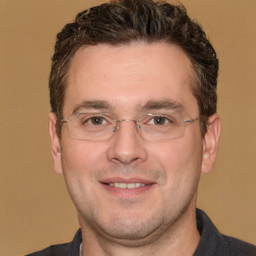 Joyful white adult male with short  brown hair and brown eyes