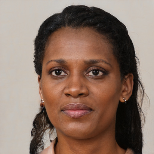 Joyful black adult female with medium  black hair and brown eyes