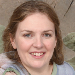 Joyful white adult female with medium  brown hair and blue eyes