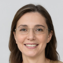 Joyful white adult female with medium  brown hair and grey eyes