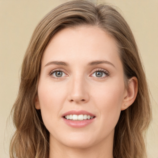 Joyful white young-adult female with long  brown hair and green eyes