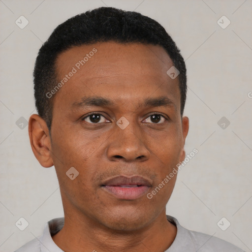 Neutral black adult male with short  black hair and brown eyes