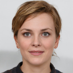 Joyful white young-adult female with medium  brown hair and grey eyes