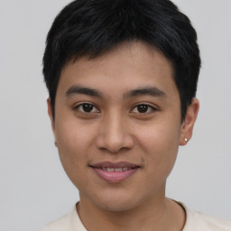 Joyful asian young-adult male with short  black hair and brown eyes