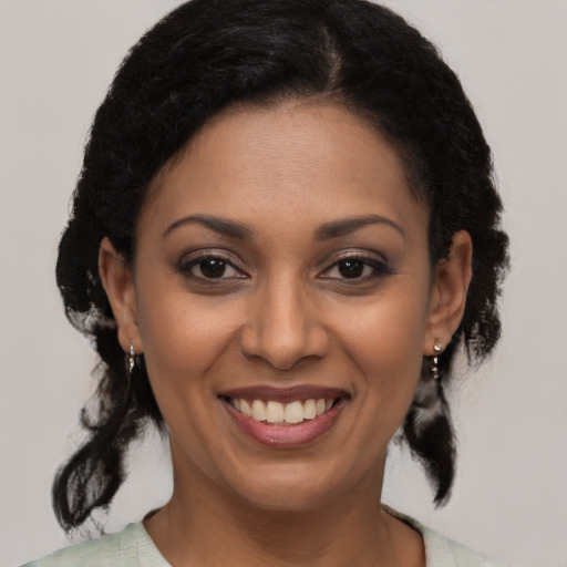 Joyful latino young-adult female with medium  brown hair and brown eyes