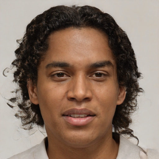 Joyful black young-adult male with short  brown hair and brown eyes