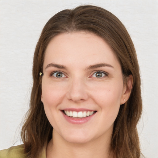 Joyful white young-adult female with medium  brown hair and blue eyes