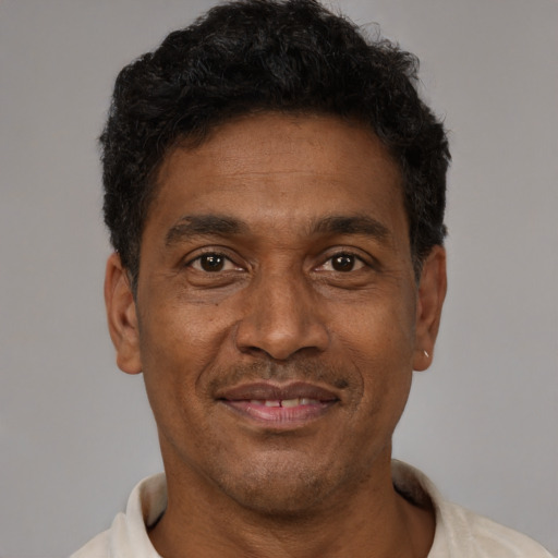 Joyful latino adult male with short  brown hair and brown eyes