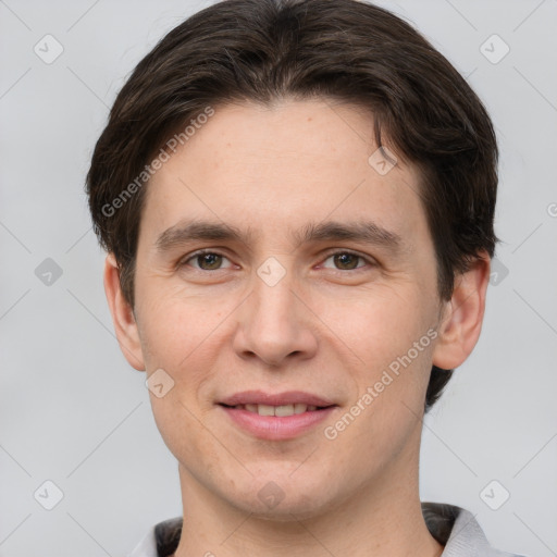 Joyful white young-adult male with short  brown hair and grey eyes