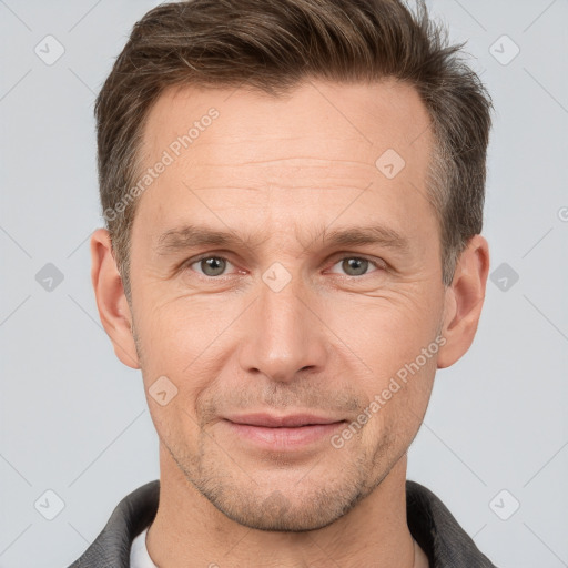 Joyful white adult male with short  brown hair and grey eyes