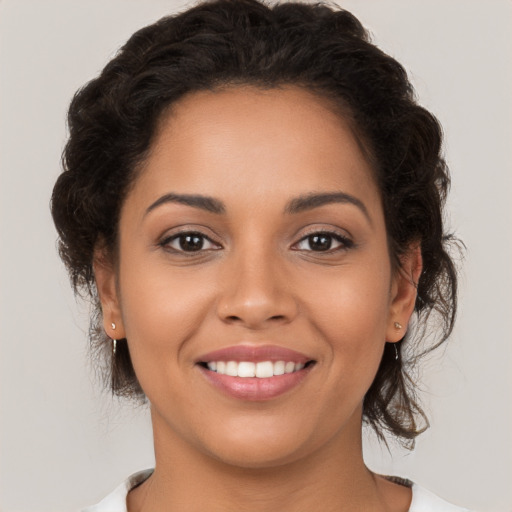 Joyful latino young-adult female with medium  brown hair and brown eyes