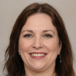 Joyful white adult female with long  brown hair and brown eyes