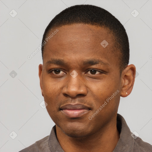 Joyful black young-adult male with short  black hair and brown eyes