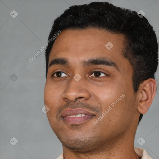 Joyful latino young-adult male with short  black hair and brown eyes
