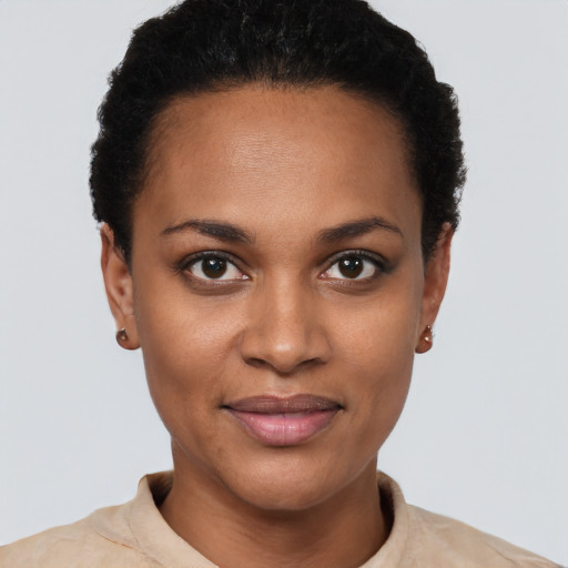 Joyful black young-adult female with short  black hair and brown eyes