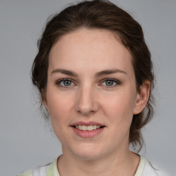 Joyful white young-adult female with medium  brown hair and green eyes