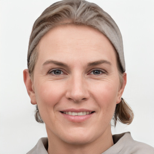 Joyful white adult female with short  brown hair and grey eyes