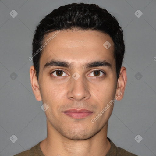 Joyful white young-adult male with short  black hair and brown eyes