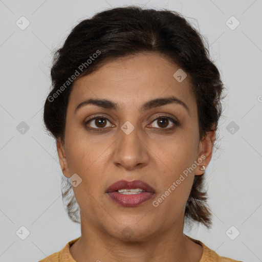 Joyful latino adult female with short  brown hair and brown eyes