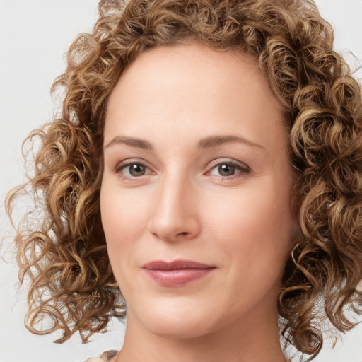 Joyful white young-adult female with long  brown hair and green eyes