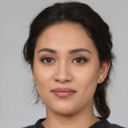 Joyful white young-adult female with medium  brown hair and brown eyes