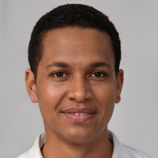 Joyful latino young-adult male with short  brown hair and brown eyes