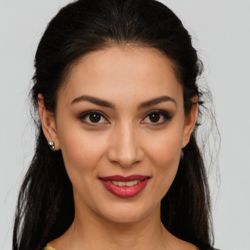 Joyful white young-adult female with long  brown hair and brown eyes