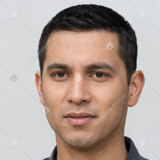 Joyful white young-adult male with short  black hair and brown eyes