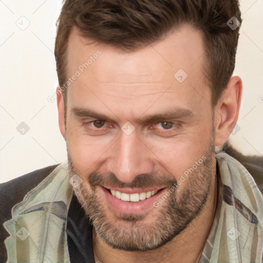 Joyful white adult male with short  brown hair and brown eyes