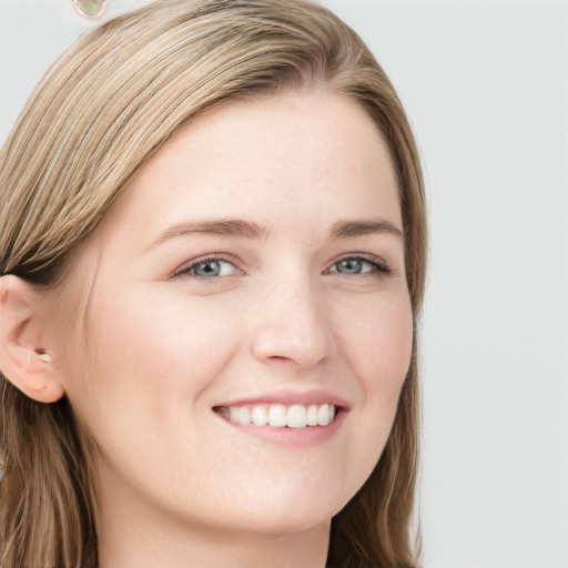 Joyful white young-adult female with long  brown hair and blue eyes