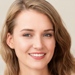 Joyful white young-adult female with long  brown hair and blue eyes