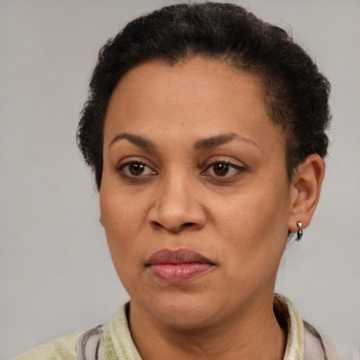 Joyful latino adult female with short  brown hair and brown eyes