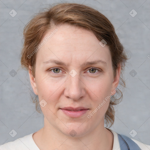 Joyful white adult female with medium  brown hair and blue eyes