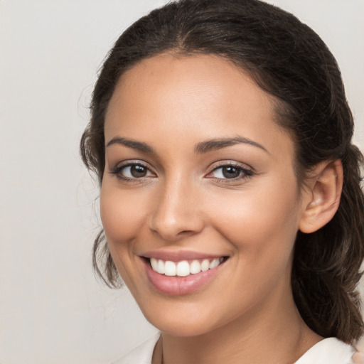 Joyful white young-adult female with medium  brown hair and brown eyes