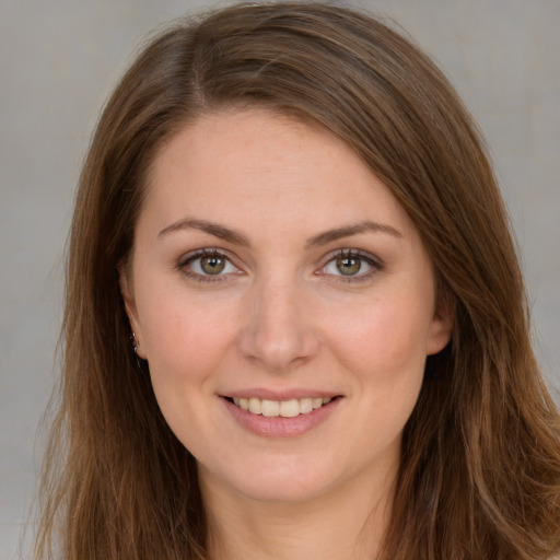 Joyful white young-adult female with long  brown hair and brown eyes