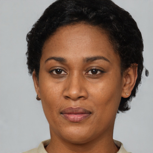 Joyful black adult female with short  brown hair and brown eyes