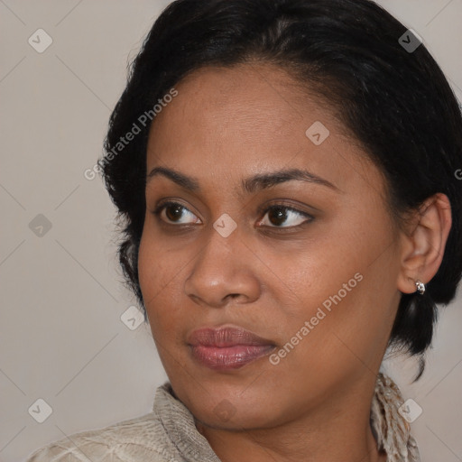 Joyful latino young-adult female with medium  brown hair and brown eyes