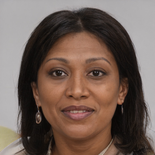 Joyful white adult female with medium  brown hair and brown eyes